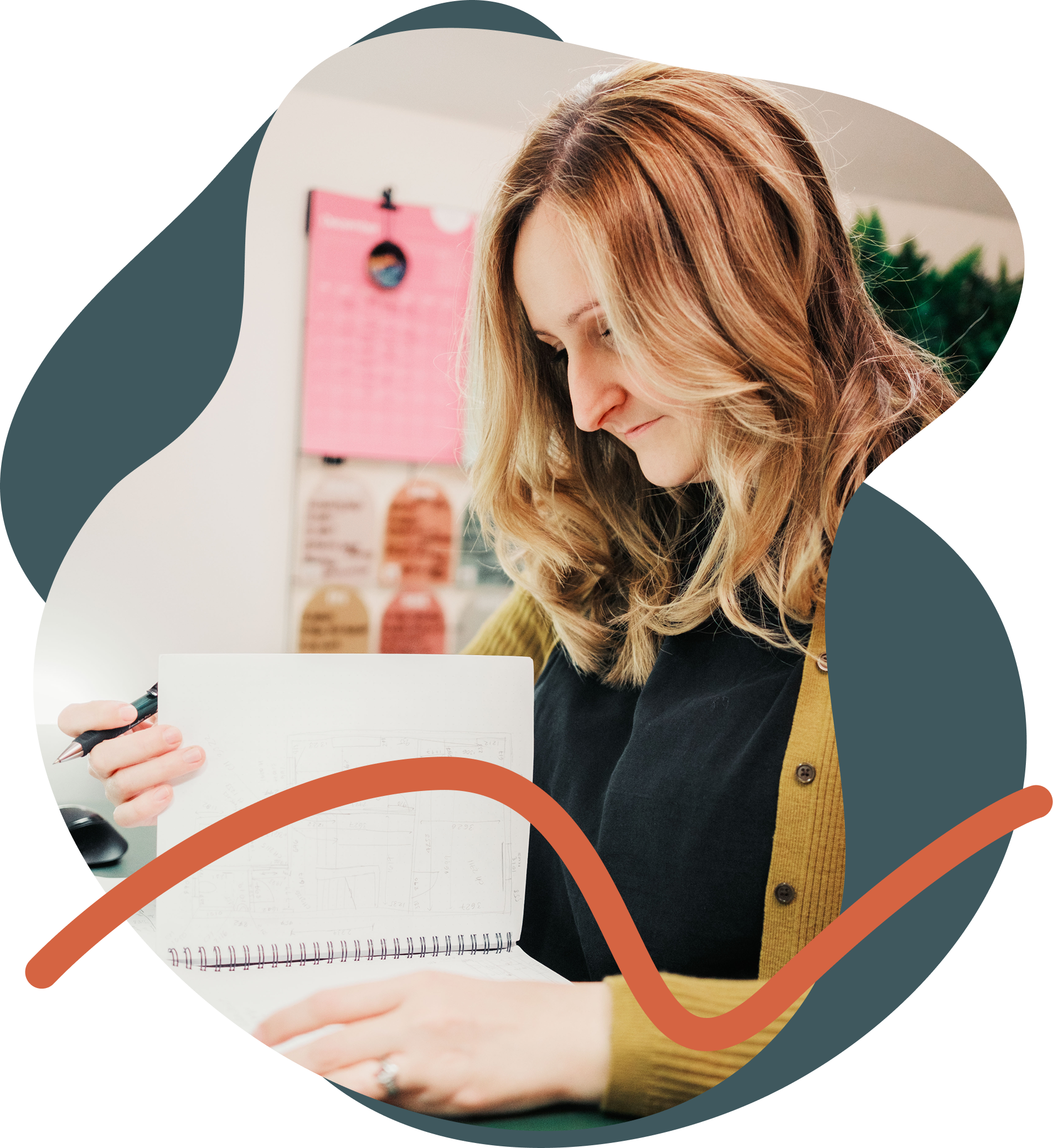 Photo of Becca at her desk looking at her notebook.
        She is wearing a mustard cardigan over a black tshirt.
        The photo is set inside a squiggly shape with a scribble on top.